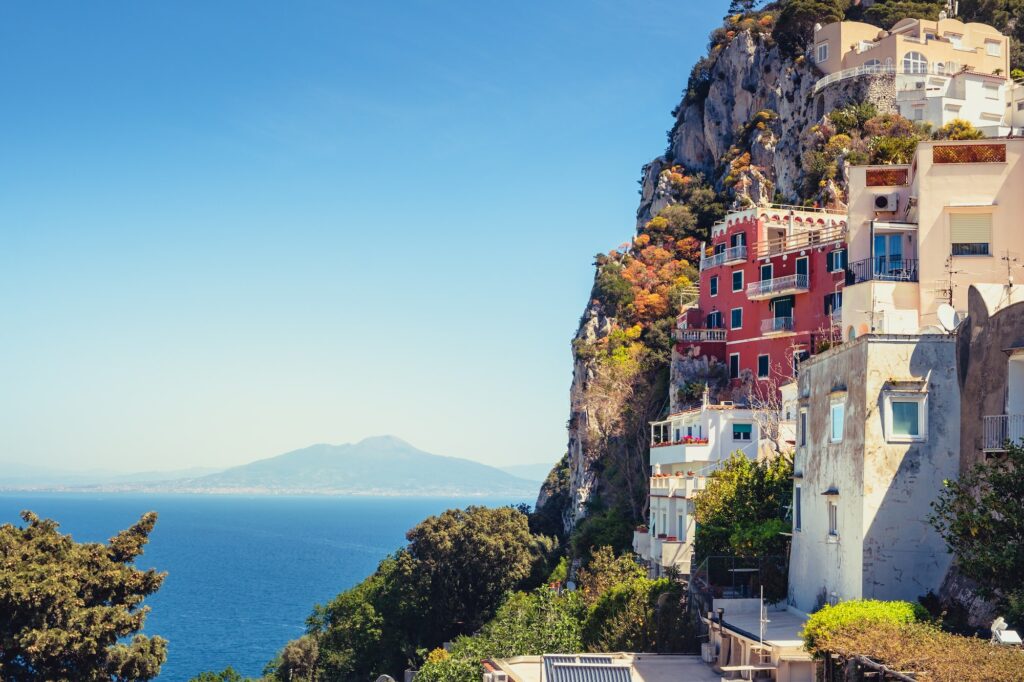 Sailing in Italy: The Ultimate Guide to Exploring the Mediterranean Waters 10 Scenic view of colorful houses on Capri island with Vesuvio background