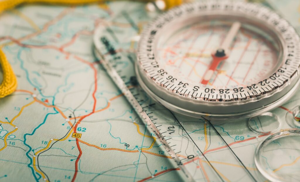 Modern compass on a map. Travel concept.